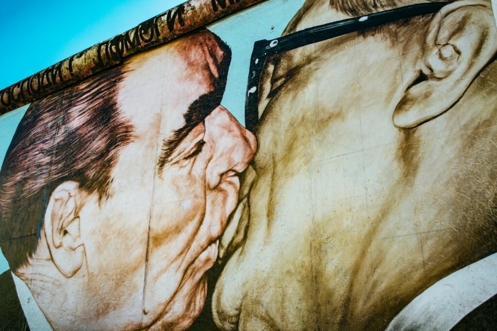 man and woman kissing painting