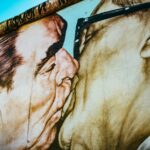 man and woman kissing painting